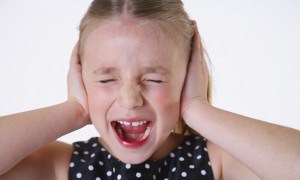 Girl with Hands over Ears Screaming